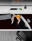 Ichigo Kurosaki silhouette on 36x16 inches anime desk pad, black robes, orange hair, Zangetsu sword, from Bleach.