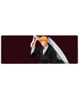 Anime mouse pad 32x12 inches featuring Ichigo Kurosaki silhouette from Bleach with black robes and orange hair on burgundy.