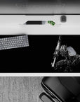 36x16 inches desk pad with Guts in his Berserker Armor, featuring a sleek black background and bold design, perfect for adding intensity and strength to your workspace.