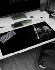 Large 40x20 inches desk pad with Guts in his Berserker Armor and massive sword, featuring a stark black backdrop for a sleek, bold design.