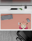 Cozy peach anime girl mouse pad 32x16 inches with pink-to-rose hair fade and playful sleepy vibe.