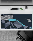 Dynamic 32x16 desk mat combines gray and blue tones with precise geometric lines for impactful yet calming visuals