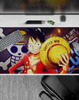 Vibrant 40x20 desk pad showcases Luffy's adventurous spirit with Straw Hat Jolly Roger backdrop