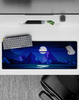 Quiet 32x12 mouse pad featuring a glowing full moon, towering mountain peaks, and a starry sky for a serene cosmic workspace look