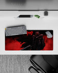 28x12 inches mouse pad showcasing Guts in his Berserker Armor, with a fiery red background and intense silhouette, perfect for a bold and powerful desk setup.