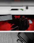 36x16 inches desk pad showcasing the raw fury of Guts in his Berserker Armor, with a fiery red backdrop and intense silhouette, perfect for a bold desk setup.