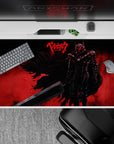 40x20 inches desk pad showcasing Guts in his Berserker Armor, with a fiery red background and powerful silhouette, capturing the raw fury of the Black Swordsman for your desk setup.