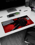 Modern 32x16 inches mouse pad with a fiery red backdrop and Guts' silhouette in his Berserker Armor, perfect for transforming your workspace with fierce energy.