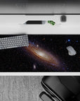 Calming deep black desk pad 36x16 inches with wispy blues, violet haze, tiny stars and amber sparks.