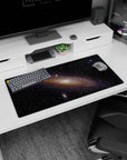 Dreamy spiral nebula scene mouse pad 32x16 inches featuring tiny stars around a luminous galaxy center.