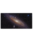Spiral galaxy space desk mouse pad 32x16 inches with starry black background and glowing core.