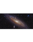Spiral galaxy starfield desk pad 36x16 inches with glowing creamy core on deep black space.