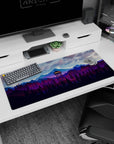 Artistic 36x16 inches mouse pad featuring mountain forest design, glowing watchtower, and purple-blue mountains for a tranquil, serene look.