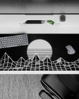 36x16 inches desk pad featuring wireframe mountains and a glowing, striped sun, capturing retro-futuristic vaporwave vibes.