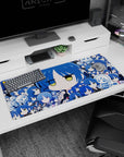 36x16 inches anime girl desk pad with big blue-haired chibi face, half-lidded yellow eyes and sleepy mini portraits.