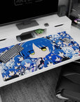 Big chibi blue-haired anime girl with half-lidded yellow eyes on desk pad 40x20 inches, school uniform and guitar.