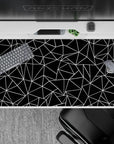 40x20 inches desk pad with bold black-and-white polygon patterns, creating a sleek, contemporary aesthetic for a stylish desk setup.