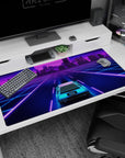 Large 40x20 inches desk pad featuring a neon cityscape with a car cruising through vibrant colors, bringing vaporwave and retrowave aesthetics to life.