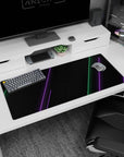 Artistic 36x16 inches desk pad featuring cyberpunk design, blending green and purple neon lines on a smooth black background for a modern tech vibe.