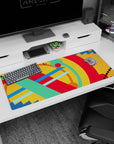 Artistic 36x16 inches desk pad featuring vibrant abstract design, with geometric strokes of red, blue, green, and yellow for an inspiring vibe.