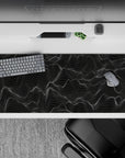 Striking 36x16 desk pad highlights intricate white lines with deep black contrast for a sense of fluid motion