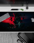 Anime desk pad 40x20 inches featuring Itachi Uchiha from Naruto, with crows, glowing city skyline, and red haze.