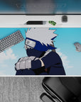 Kakashi Hatake from Naruto on a 40x20 inch anime desk pad, featuring a serene sky and muted navy tones.