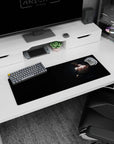 Sly red-eyed anime girl looking over her shoulder on mouse pad 32x12 inches, strappy black outfit and blades.