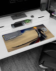 Modern 32x16 inches mouse pad featuring Ichigo wielding Zangetsu against desert winds with deep blues and golden sands for strength.