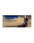 Mouse pad featuring Ichigo Kurosaki, 28x12 inches, with Zangetsu in desert winds and golden sands for a bold anime look.
