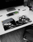 Anime girl lounging with teasing gaze on mouse pad 32x16 inches, hand near lips, armor and leggings.