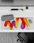 Intense 32x12 desk mat features bold ribbons and vibrant tones with intricate details for fans of abstract art