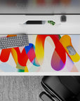 Striking 36x16 desk pad highlights bold red, yellow, blue, and orange tones with intricate flowing details in stunning artistry