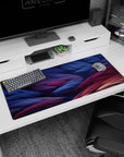 Artistic 36x16 inches desk pad showcasing abstract fiber waves in blue, purple, and red, perfect for adding depth and inspiration to your desk.