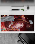 Megumin anime mouse pad 32x16 inches featuring her wild grin, crimson eyes, and Chomusuke, with magical rainbow stars.