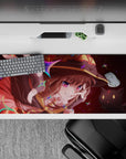 Megumin anime desk pad 36x16 inches, featuring her wild grin, sparkling crimson eyes, and Chomusuke, full of vibrant energy.