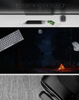 Tranquil 40x20 desk pad with a moonlit forest scene, crackling campfire, and a starry sky, capturing the calm and mystery of a night retreat