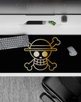 36x16 inches desk pad with the Straw Hat Pirates' golden Jolly Roger from One Piece, showcasing the bold emblem in a minimalistic design.