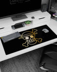 Artistic 36x16 inches desk pad with the Straw Hat Pirates' golden Jolly Roger from One Piece, capturing the essence of adventure in a sleek design.