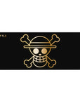 Desk pad featuring the Straw Hat Pirates' golden Jolly Roger from One Piece, 36x16 inches, with a sleek golden emblem on a black background.