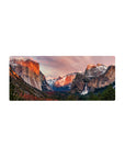 Mouse pad featuring mountain landscape design, 28x12 inches, with sun-kissed cliffs, snow-capped peaks, and a stunning waterfall for a tranquil, adventure-filled look.