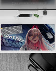 Neon-lit 32x16 mouse pad with Power, sharp fangs, and glowing city lights, creating a rebellious, fiery desk environment for anime fans