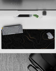 32x12 inches mouse pad with sleek gold topographic patterns on a deep black background, perfect for a sophisticated and stylish workspace.