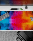 40x20 inches desk pad showcasing vibrant cosmic color bursts with bold blues, pinks, and oranges, ideal for adding inspiration and a pop of color to your desk setup.