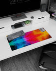Cosmic Color Burst mouse pad, 28x12 inches, showcasing chaotic, colorful bursts perfect for adding dynamic inspiration to your desk setup.