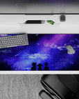 Anime desk pad featuring dreamy skies with shooting stars, silhouettes under a galaxy in purples and blues, 36x16 inches.
