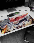 Red-haired anime warrior girl glares forward as flames flare behind her on a 40x20 inches desk pad.