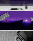 Peaceful 40x20 desk pad with silhouetted mountains and trees against a starry night sky in purple hues, perfect for nature lovers