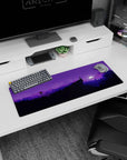 Serene 32x12 mouse pad showcasing a moonlit wilderness with purple mountains, trees, and a starry sky for a tranquil workspace design