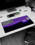 Tranquil 32x16 mouse pad with silhouetted mountains and trees, bathed in purple hues, capturing the serenity of the outdoors at night
